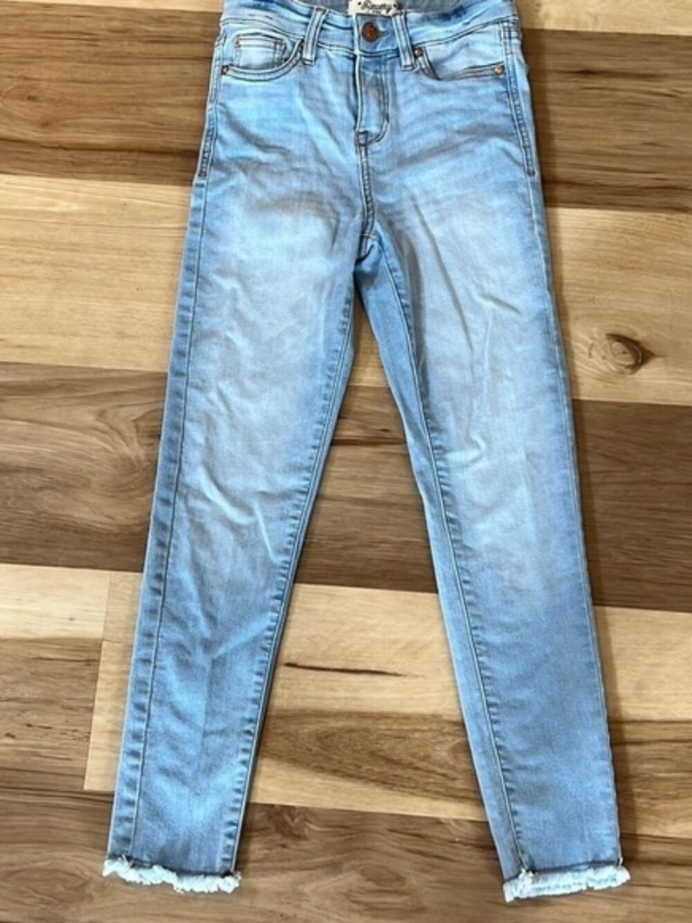 Cute girls skinny jeans with frayed bottom. Size 10